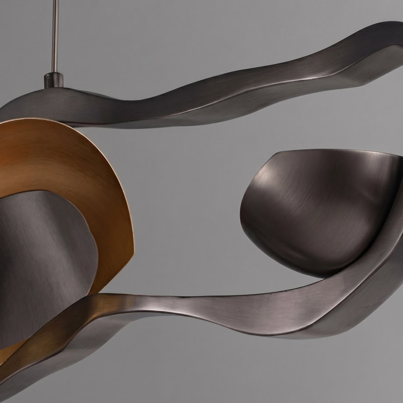 Black Designer Sculptural Pendant Light NOVARA LG363 with flowing curvilinear metal rings in a black and gold finish above an interior setting