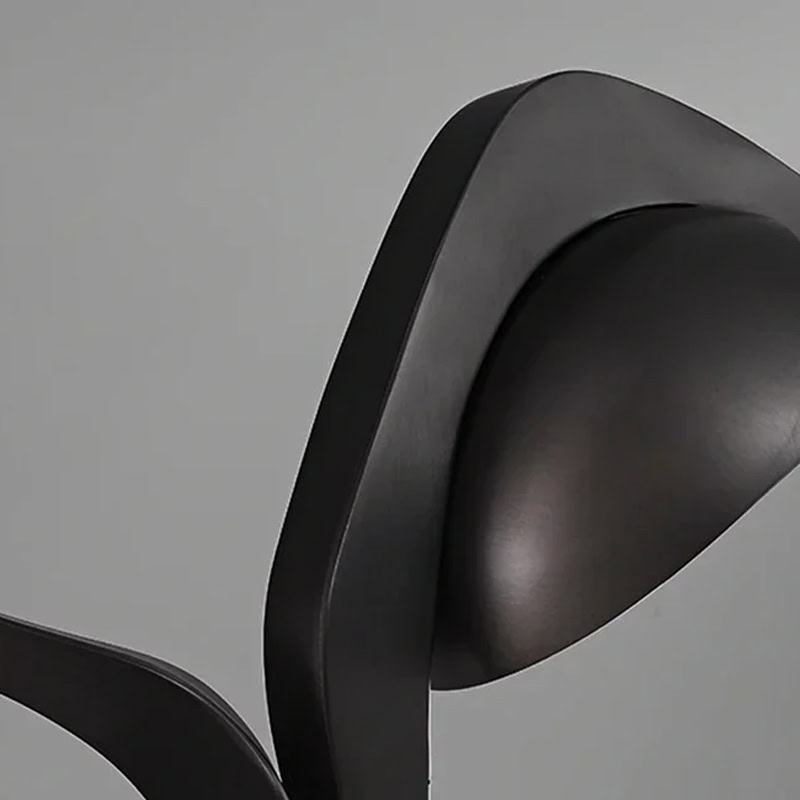 Black Designer Sculptural Pendant Light NOVARA LG363 with flowing curvilinear metal rings in a black and gold finish above an interior setting