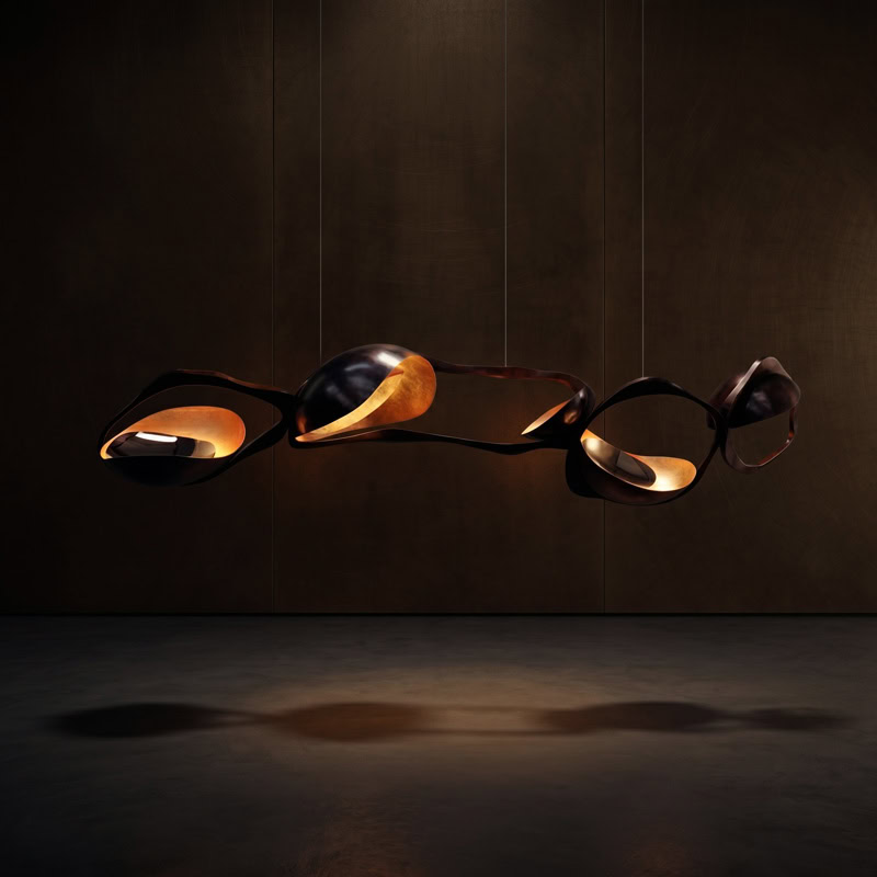 Black Designer Sculptural Pendant Light NOVARA LG363 with flowing curvilinear metal rings in a black and gold finish above an interior setting