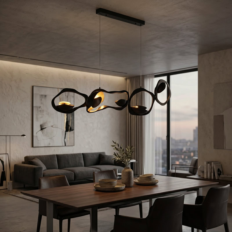 Black Designer Sculptural Pendant Light NOVARA LG363 with flowing curvilinear metal rings in a black and gold finish above an interior setting
