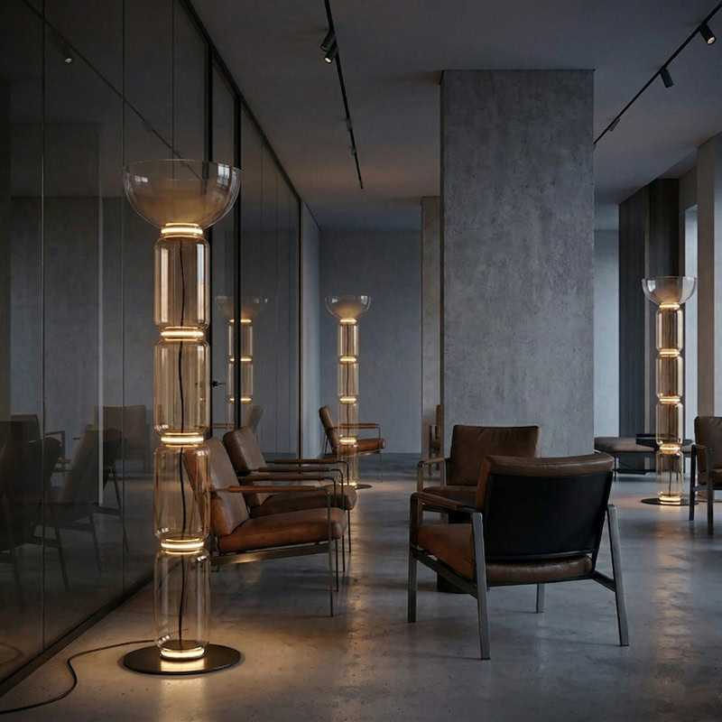 Modern Glass Column Floor Lamp FOSCHO LG356 with stacked clear glass cylinders and matte black frame, casting soft ambient light in a contemporary interior space.