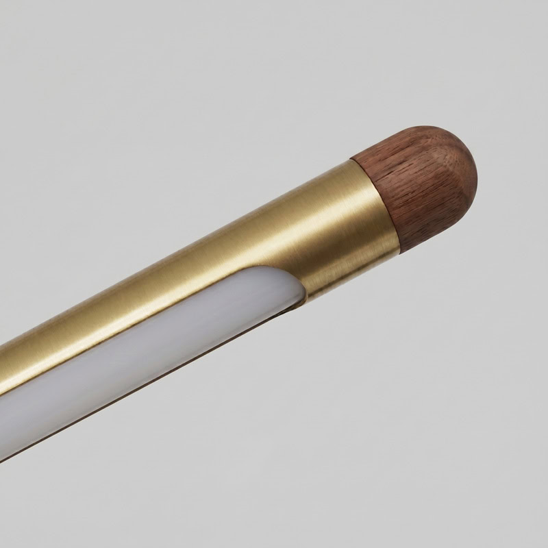 Walnut brass linear pendant light with integrated LED suspended over interior space